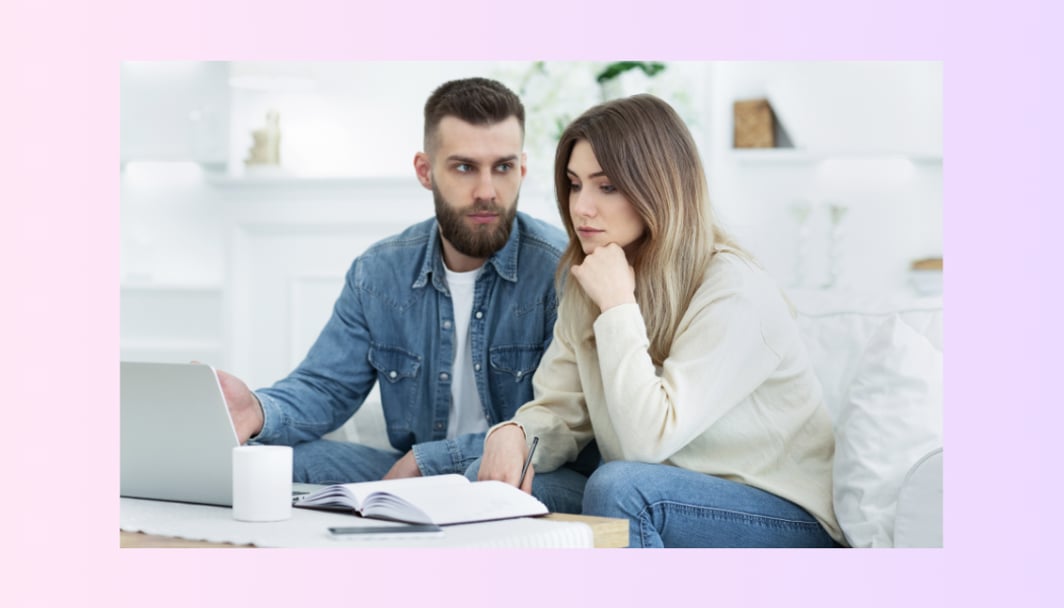 A couple looking worried, representing the cash rate hike by the RBA.