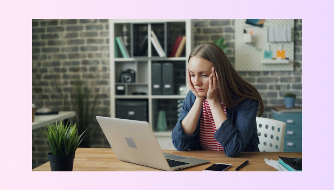 A lady looking at a screen and wondering about the cash rate representing the topic, "Will interest rates go down? What borrowers should do when the outlook is uncertain"